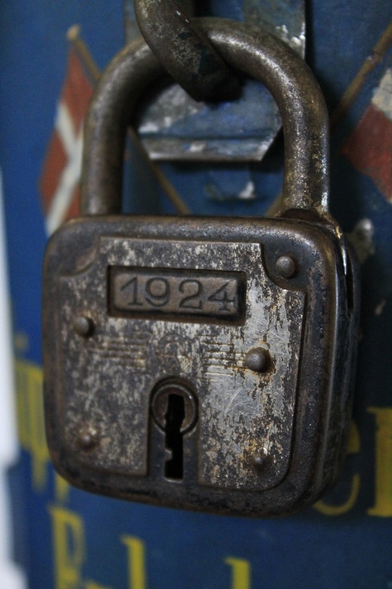 an old padlock on a door with a chain